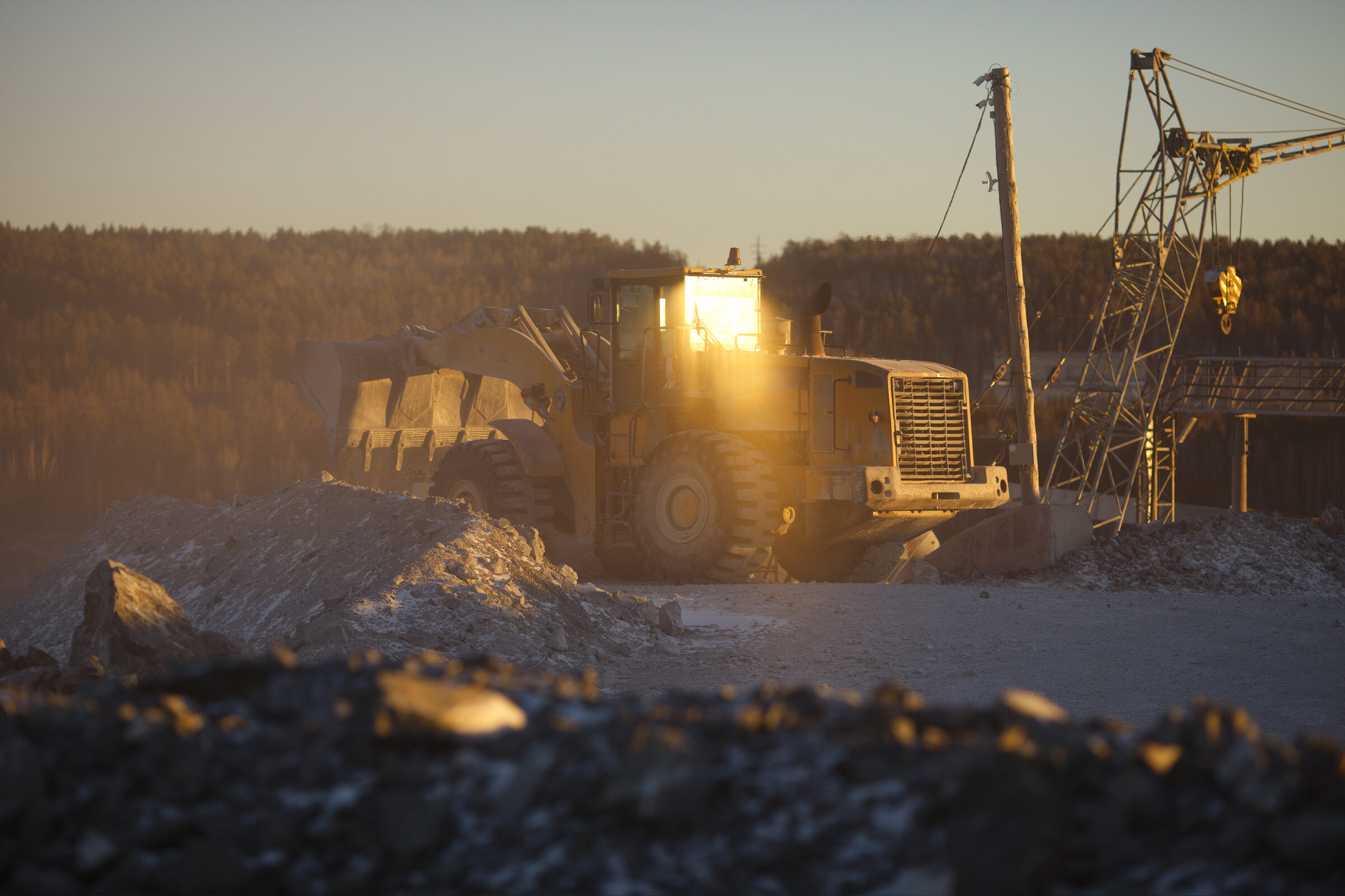 Heavy wheel loader at golden hour in quarry
