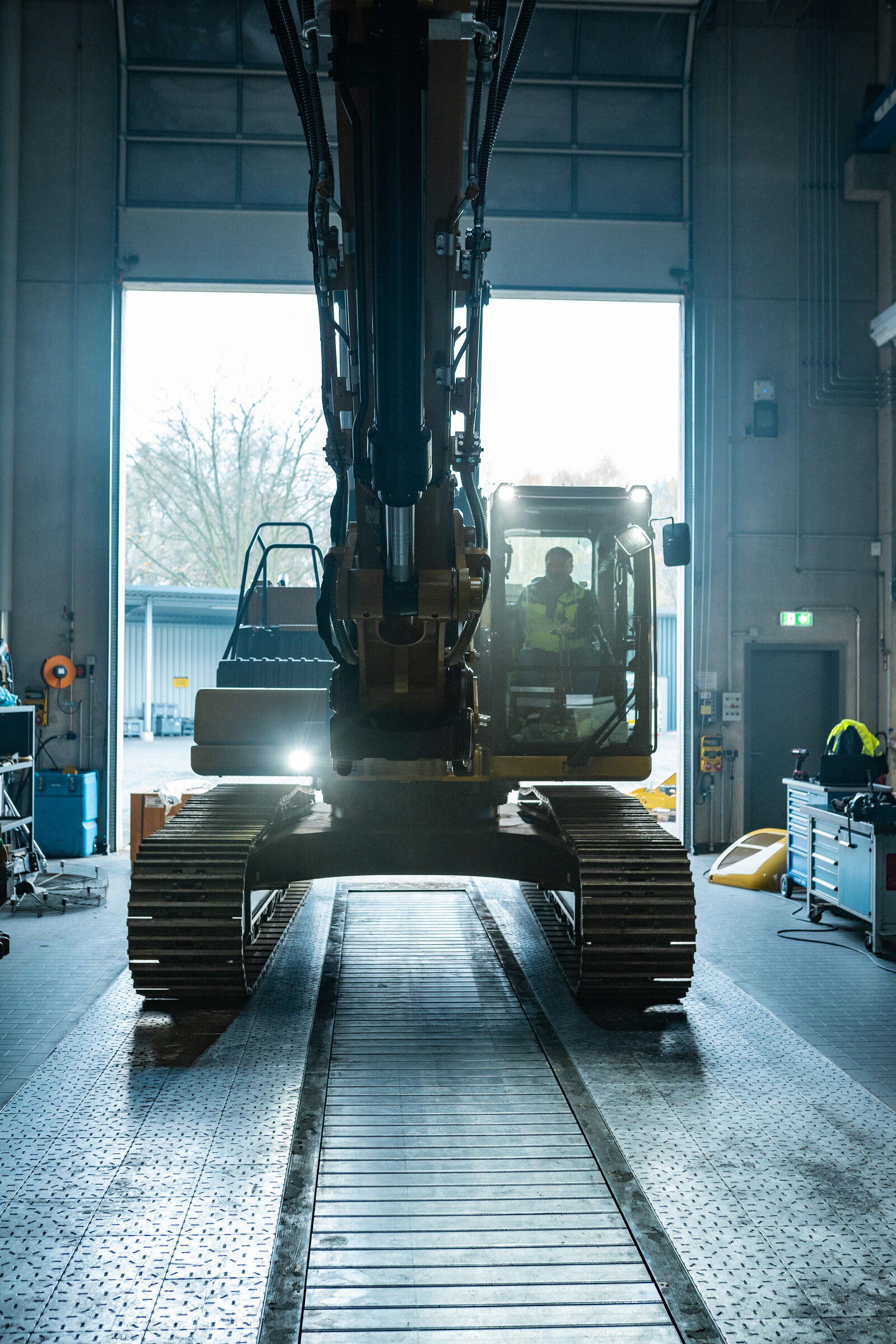 Excavator in workshop bay